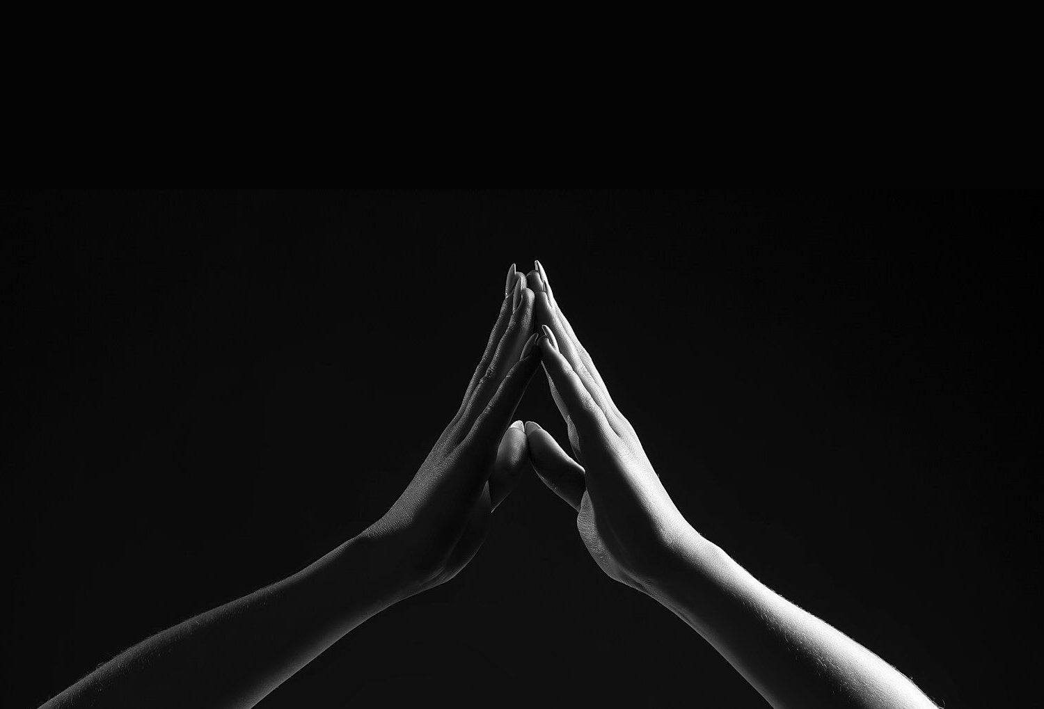 person's hands forming triangle